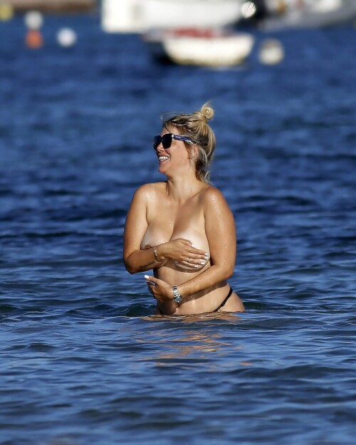 Wanda Nara goes all out in Ibiza, flaunting her big sexy breasts with a daring hand bra and a barely-there thong bikini. The beach has never been hotter!