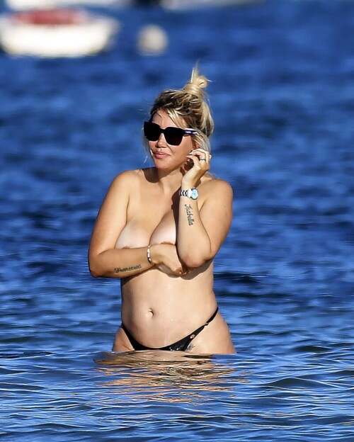 Wanda Nara goes all out in Ibiza, flaunting her big sexy breasts with a daring hand bra and a barely-there thong bikini. The beach has never been hotter!