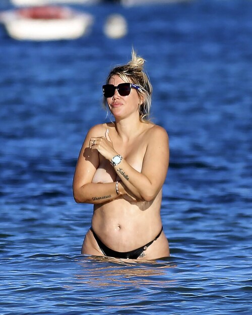 Wanda Nara goes all out in Ibiza, flaunting her big sexy breasts with a daring hand bra and a barely-there thong bikini. The beach has never been hotter!