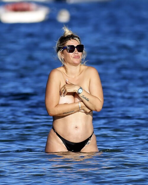 Wanda Nara goes all out in Ibiza, flaunting her big sexy breasts with a daring hand bra and a barely-there thong bikini. The beach has never been hotter!