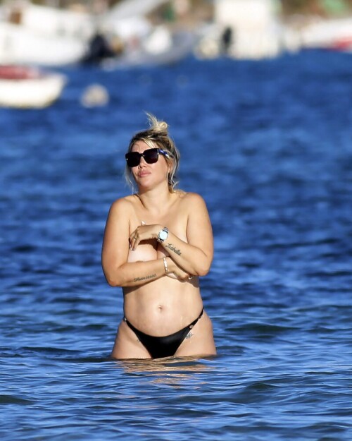 Wanda Nara goes all out in Ibiza, flaunting her big sexy breasts with a daring hand bra and a barely-there thong bikini. The beach has never been hotter!